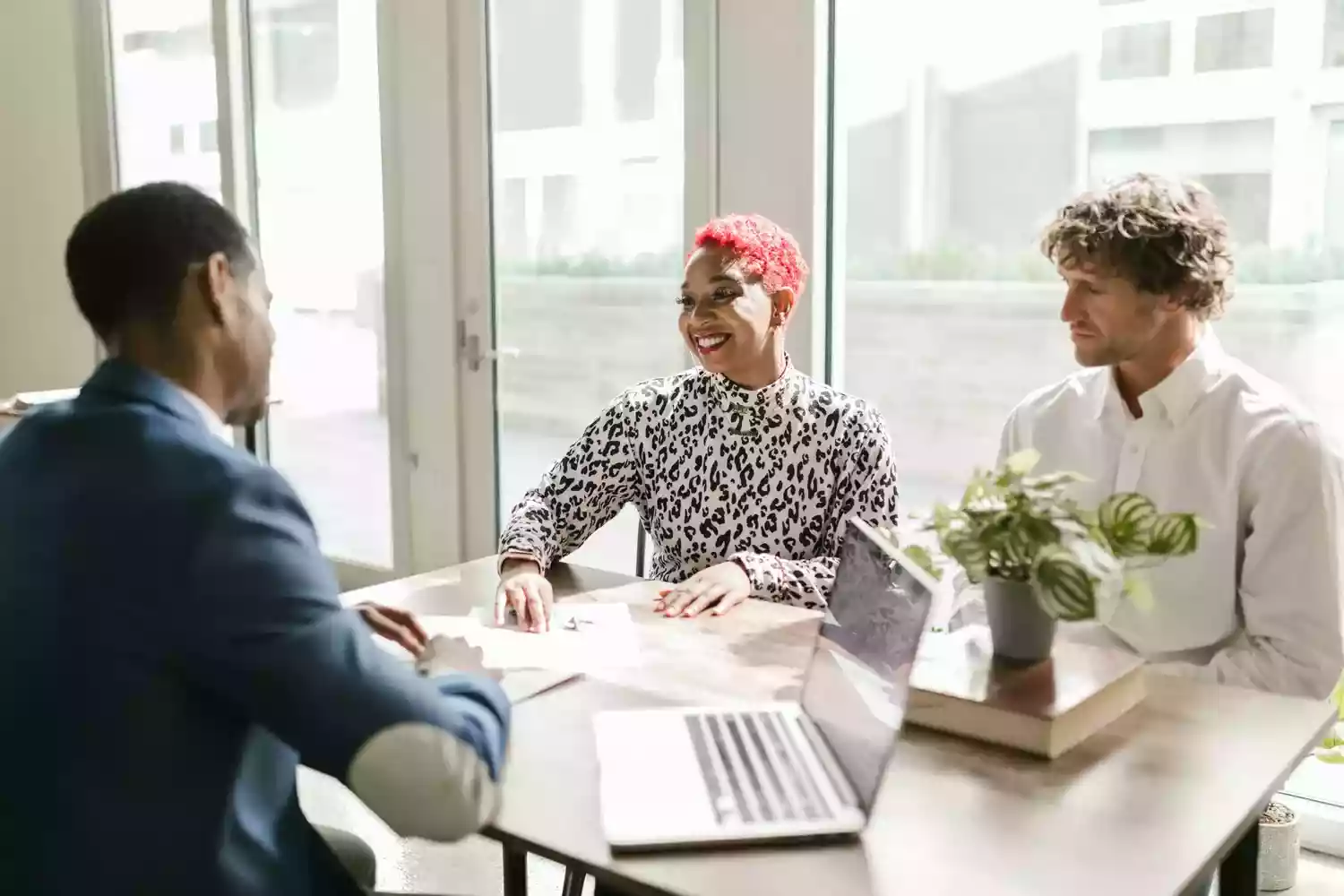 Three people working at a desk